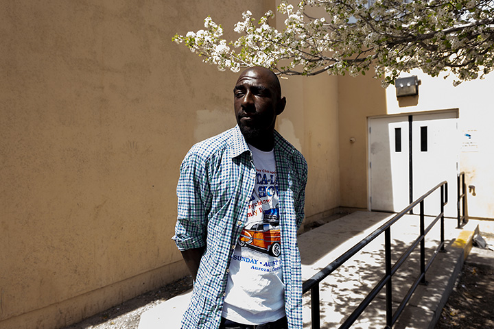 Man experiencing homeless standing outside homeless shelter