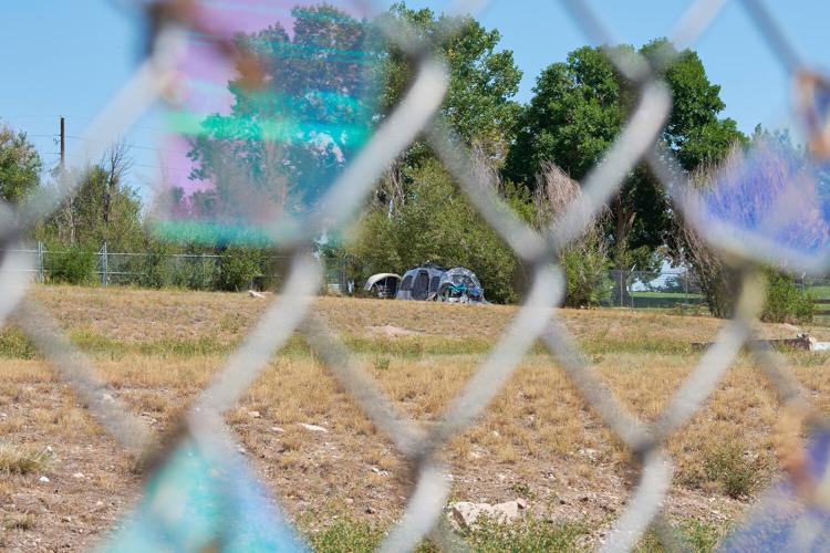 tent in field through fence